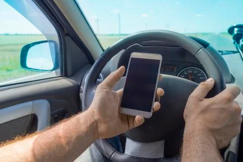 Man using cellphone while driving. Stock Photos