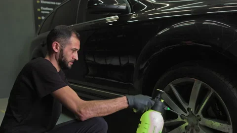 Man using chemistry for cleaning sport car wheel, slow motion. Male hand Stock Footage 141024057
