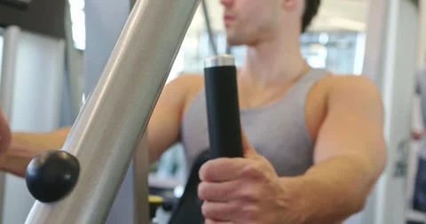 Man Using Chest Press Machine at the Gym Stock Footage 323775187