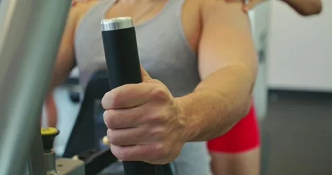 Man Using Chest Press Machine at the Gym Stock Footage 323775527