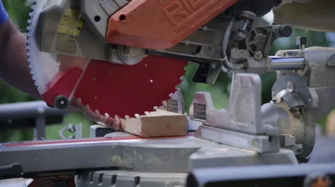 Man using Chop Saw and measuring outside on a construction site Stock Footage 65092918