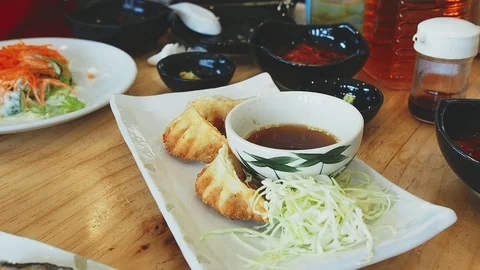 A man using chopsticks for eating dry-fried dumplings Video stock 109039386