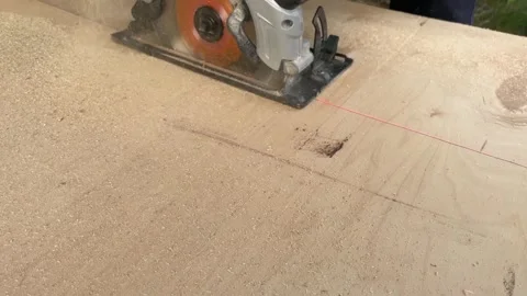 Man using a circular saw to cut plywood Stock Footage 247915138