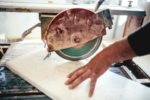 Man using circular saw for cutting slate and marble Stock Photos