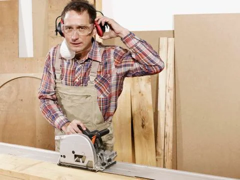 A man using a circular saw Stock Photos