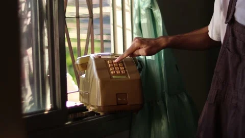 Man using an classic telephone and listening to the radio by the window. Stock Footage 170541942