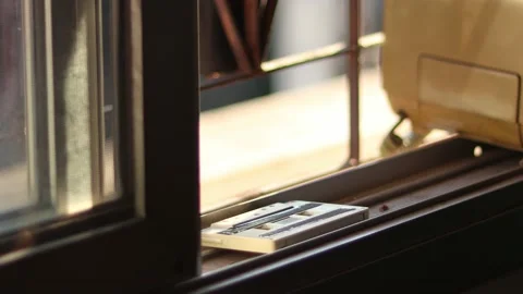Man using an classic telephone and listening to the radio by the window. Stock Footage 170541956