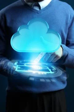 Man using cloud technology to interact with digital display in a tech setting 스톡 사진