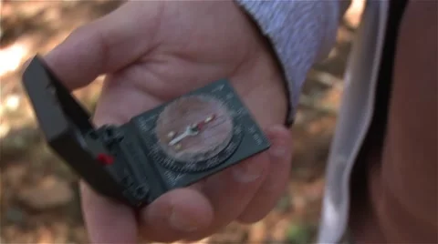 Man using a compass Stock Footage 56948901