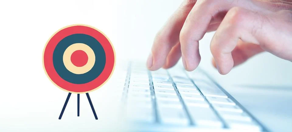 Man using a computer against target on white background with vignette Stock Photos