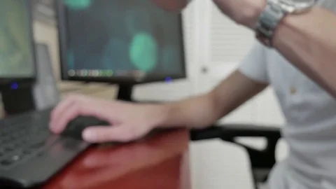 A man using a computer and drinking from a cup Stock Footage 75485050