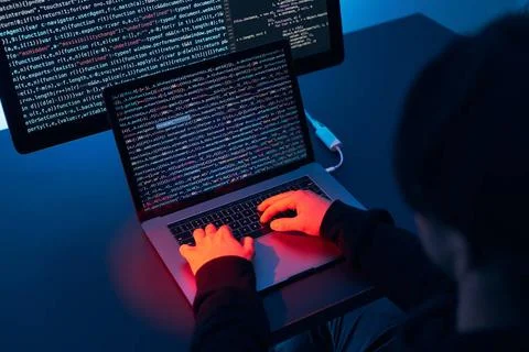 Man using computer and programming to break code. Cyber security threat. I... 库存照片