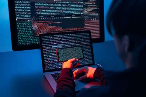 Man using computer and programming to break code. Cyber security threat. I... 库存照片