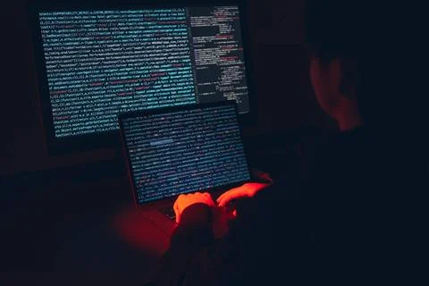 Man using computer and programming to break code. Cyber security threat. I... 库存照片