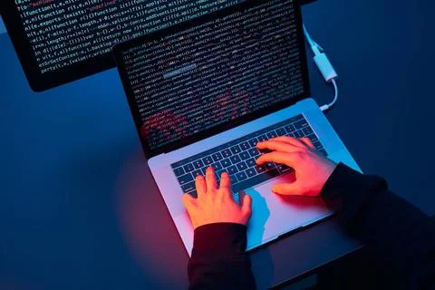 Man using computer and programming to break code. Cyber security threat. I... Stockfoto's