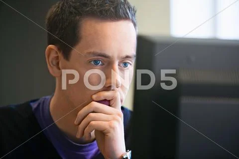 Man Using Computer At Desk