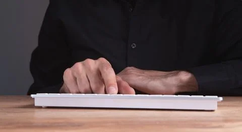 Man using a computer on desk Stock Photos