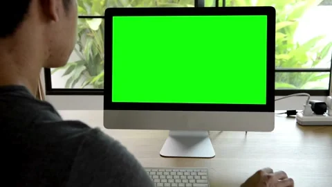 Man using computer with green screen monitor in office Video stock 334108414