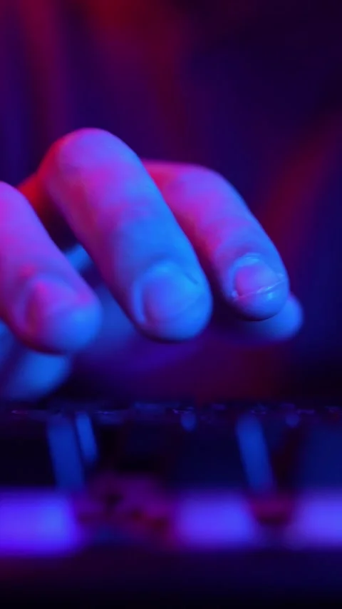 Man Using Computer Keyboard Code Website in Neon Lighting. Hacker and Cybercrime Stock Footage 232976975