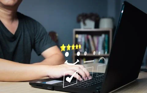 Man using computer laptop choose the happy smile face icon to give satisfac.. Stock Photos
