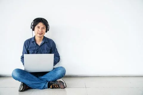 Man using computer laptop smiling and listening nice music and feel relieved Stock Photos