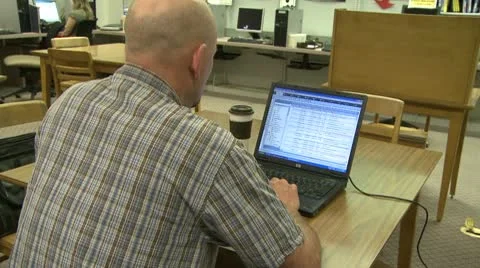Man using a computer in a library Video stock 10774539