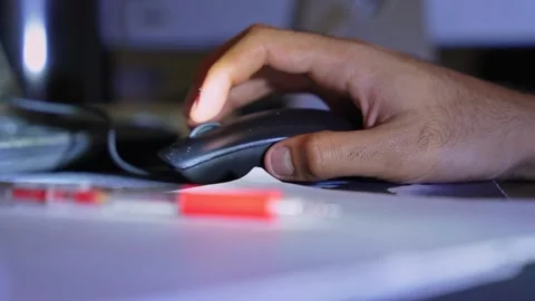 Man using computer mouse at night Stock Footage 334408597