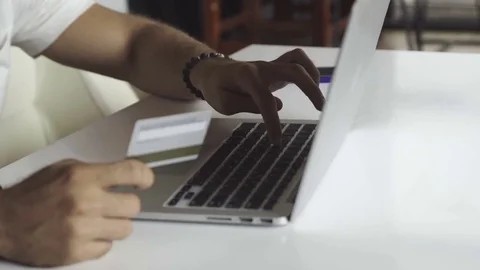 Man using computer for online shopping Stock Footage 83929797