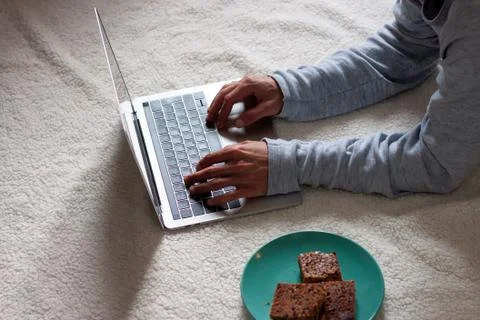 Man using computer while resting on the floor. White background Foto stock