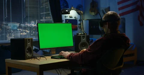 Man using a computer while wearing VR headset Stock Footage 105346473