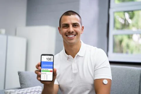 Man Using Continuous Glucose Remote Monitor Stock Photos