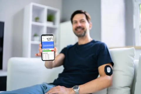 Man Using Continuous Glucose Remote Monitor Diabetes Stock Photos