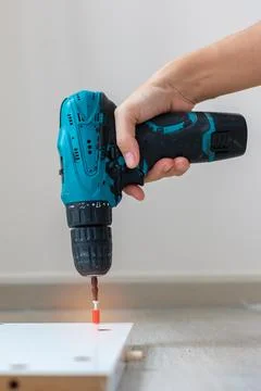 Man using a cordless screwdriver assembling furniture at home, Carpenter wo.. Stock Photos