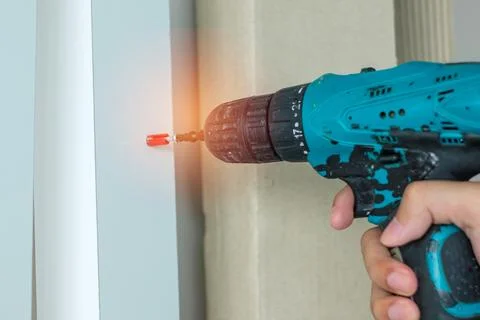 Man using a cordless screwdriver assembling furniture at home, Carpenter wo.. Stock Photos