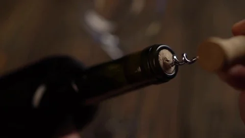 Man using cork screw for uncork wine bottle before drinking Stock Footage 123916212