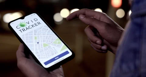 Man using covid tracker app on mobile phone outdoors Stock Footage 147362590
