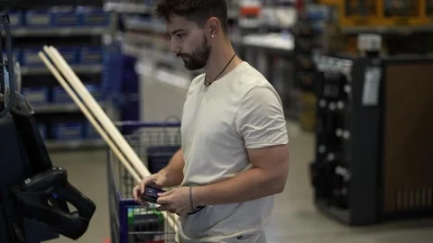 Man using credit card to pay for purchases at self checkout in hardware store. Stock Footage 280770746