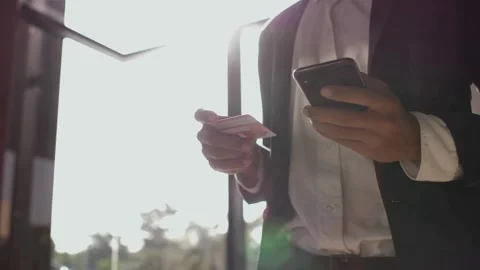 Man using Credit card for payment on mobile phone and credit bank card succes Stock Footage 265928703