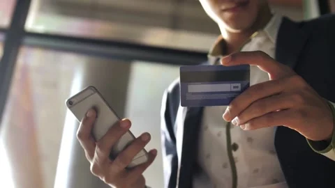Man using Credit card for payment on mobile phone and credit bank card succes Stock Footage 265931482