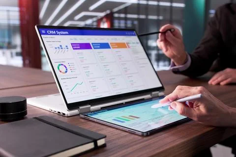 Man Using CRM Software On Laptop To Support Global Sales. Stock Photos