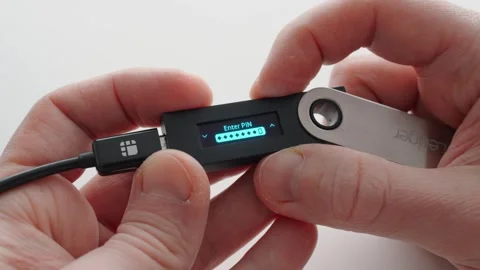 Man using a crypto hardware wallet. Entering an invalid PIN code. Ledger Nano 스톡 동영상 296783091