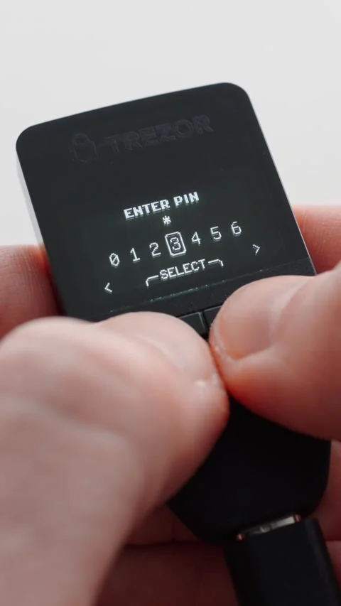 Man using a crypto hardware wallet. Entering the PIN code. Trezor Safe 3. Close 스톡 동영상 310188362