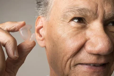 Man using custom made silicone earplugs for protection Stock Photos