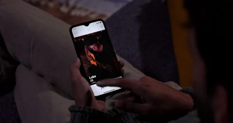 Man using dating app on mobile phone at home Stock Footage 147403863
