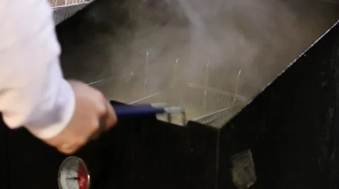 Man using deep fryer (N) Stock Footage 43489313