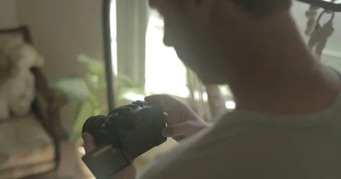 Man using digital camera at home Stock Footage 78037721