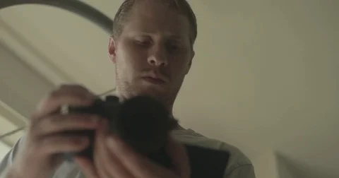 Man using digital camera at home Stock Footage 78037749