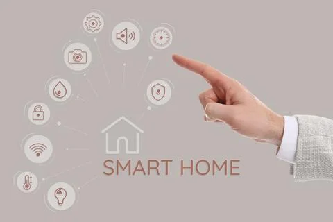 Man using digital screen with Smart Home interface on beige background, close Stock Photos