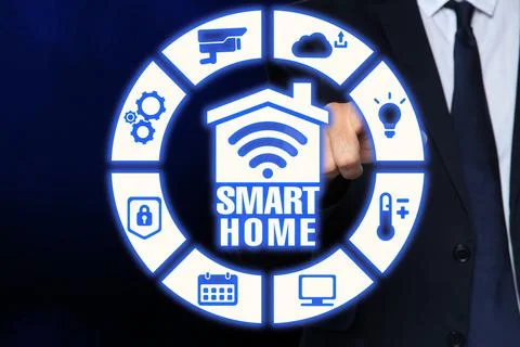 Man using digital screen with Smart Home interface on dark blue background,.. Stock Photos