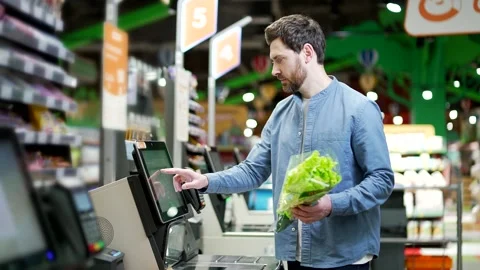 Man using digital self-service checkout in modern supermarket. Male customer Stock Footage 343616062